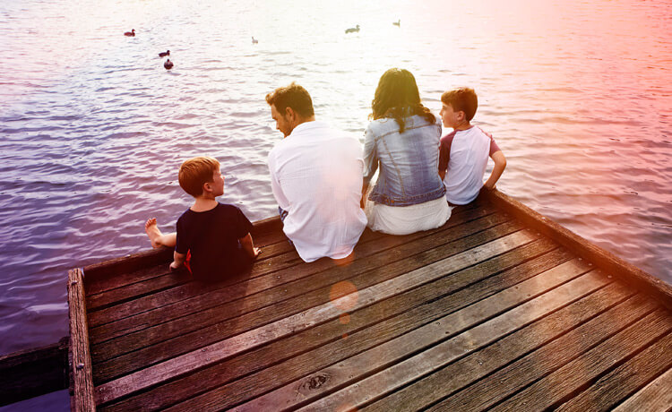 Family by lake with Virgin Income Protection Insurance