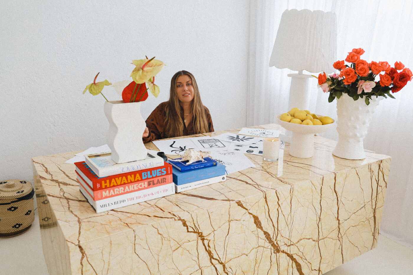 Digital nomad, Sophie bell sits at her desk in a luxe location